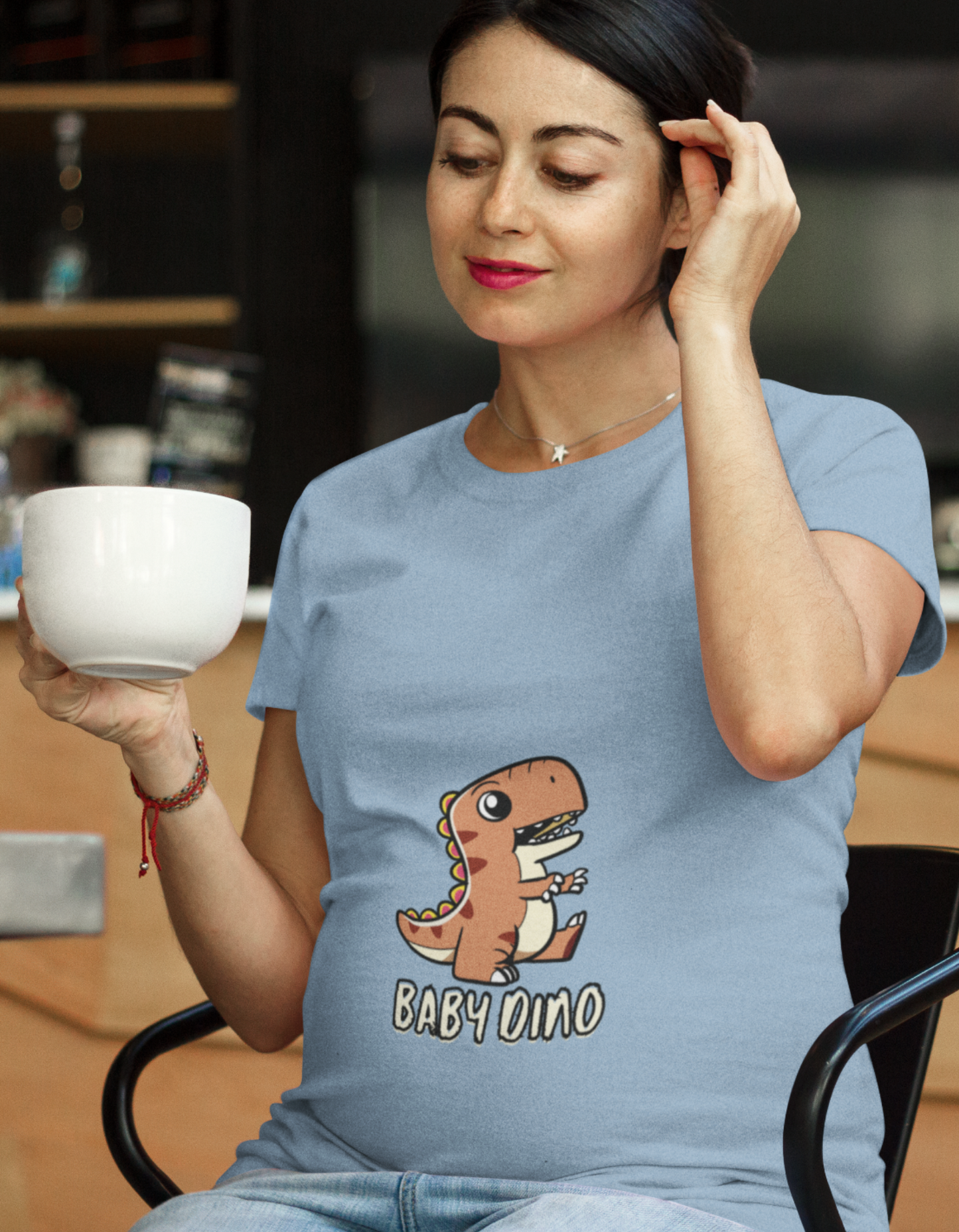 Celebrate motherhood in a fun and stylish way with our Baby Dino Pregnancy T-Shirt from Womanitee. Experience the perfect blend of comfort and cuteness. Shop online for trendy women's t-shirts!