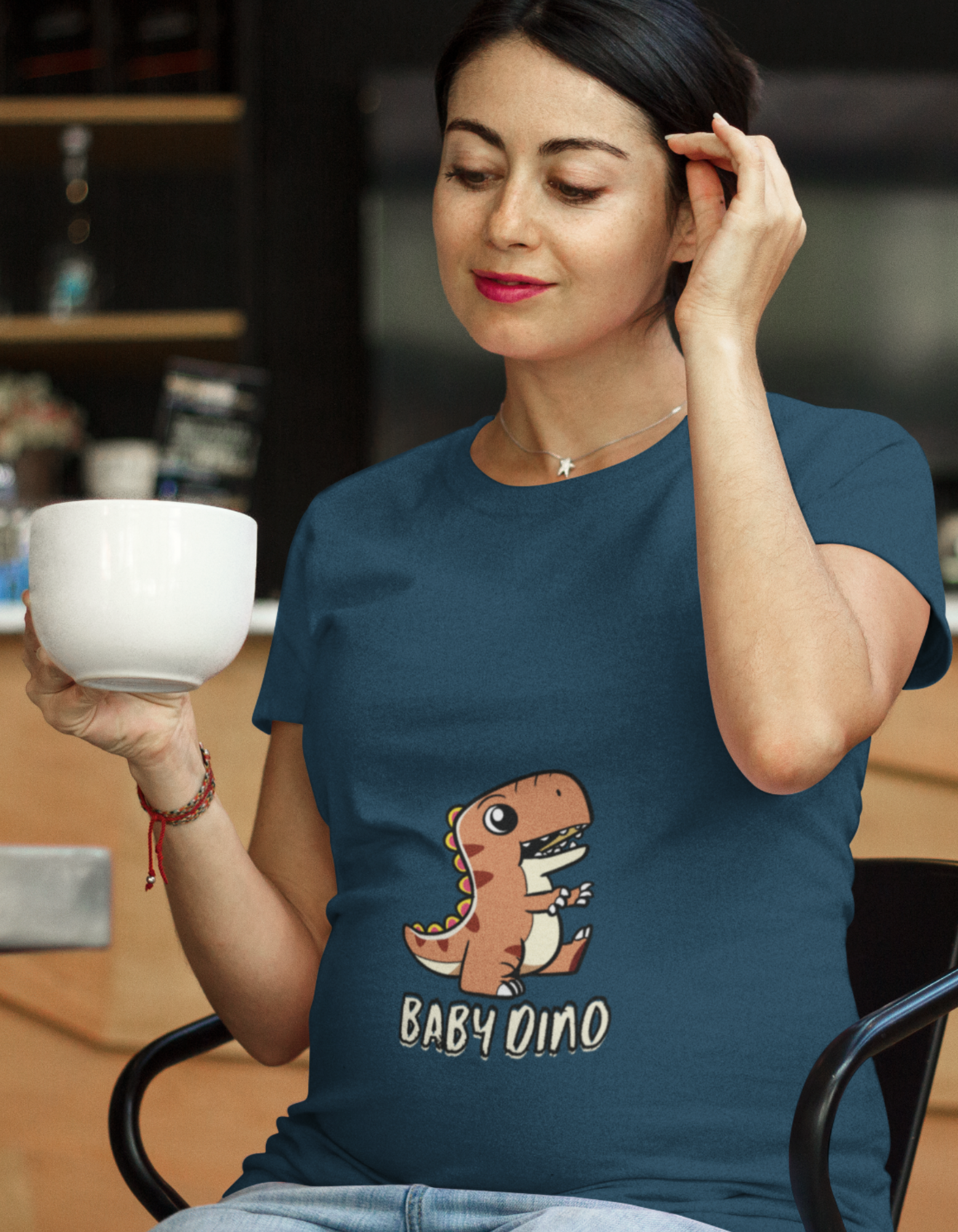 Unleash your inner mama-saurus and show off your sense of humor with our Baby Dino Pregnancy T-Shirt from Womanitee. Stay comfy and cute throughout your pregnancy. Shop now for trendy women's t-shirts!