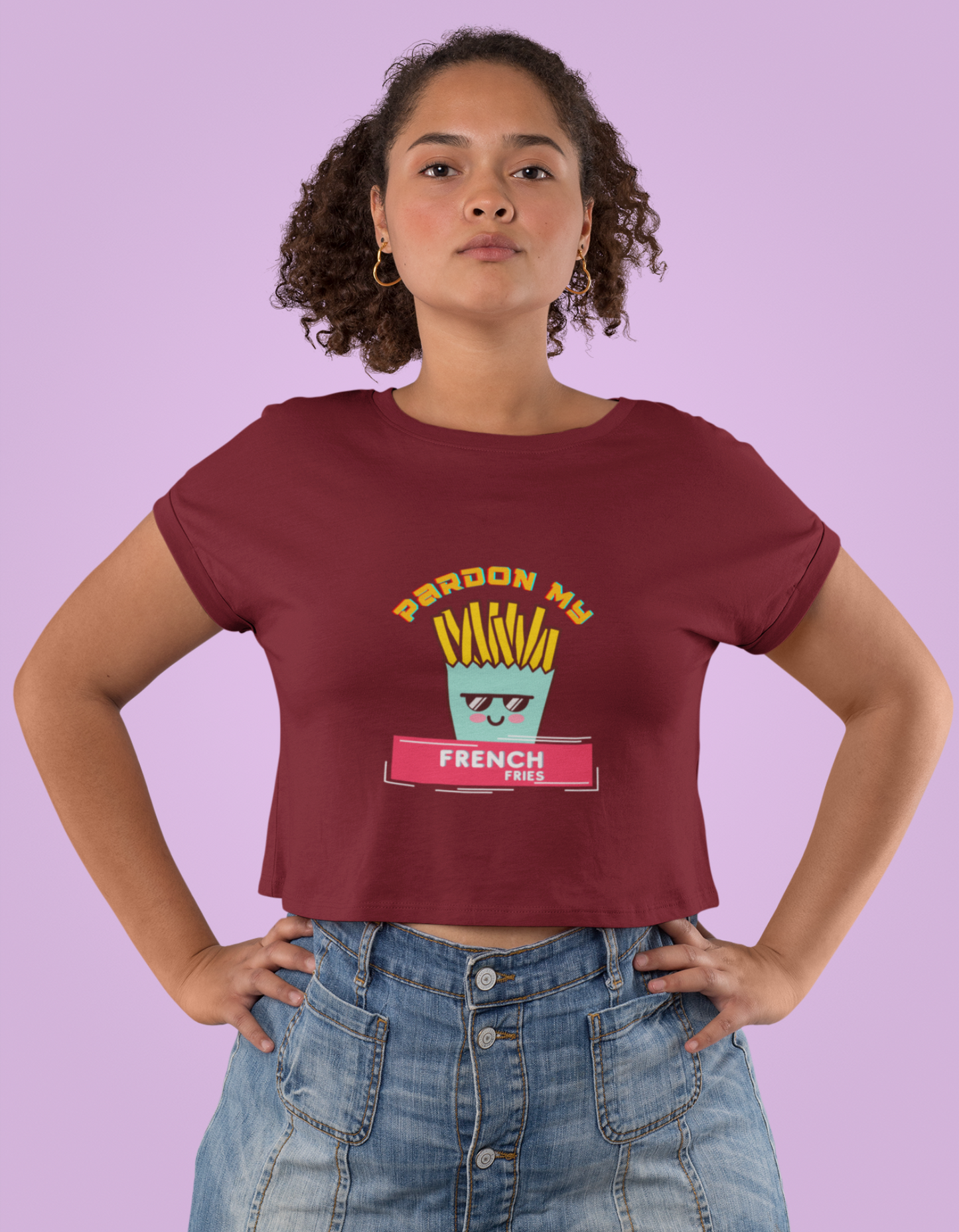 Stand out from the crowd with our maroon crop top showcasing a playful pack of french fries. Show off your unique fashion sense and love for fries. Shop today!