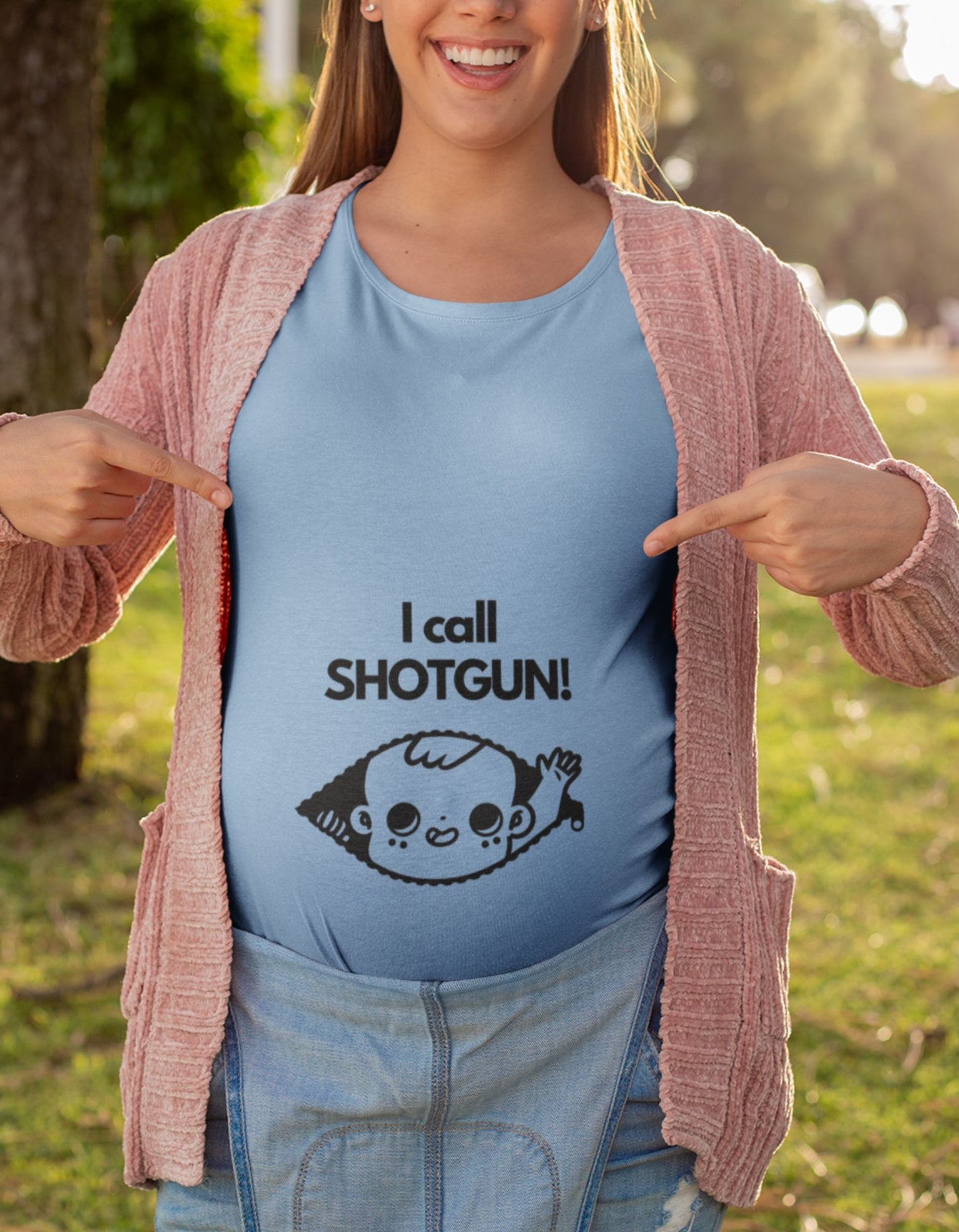 Celebrate the adventure of motherhood with our oversized pregnancy t-shirt. Featuring a cute baby peaking out of a zip and raising a hand, our 'I Call Shotgun' t-shirt combines comfort, style, and a touch of humor. Shop now and make a statement at Womanitee!