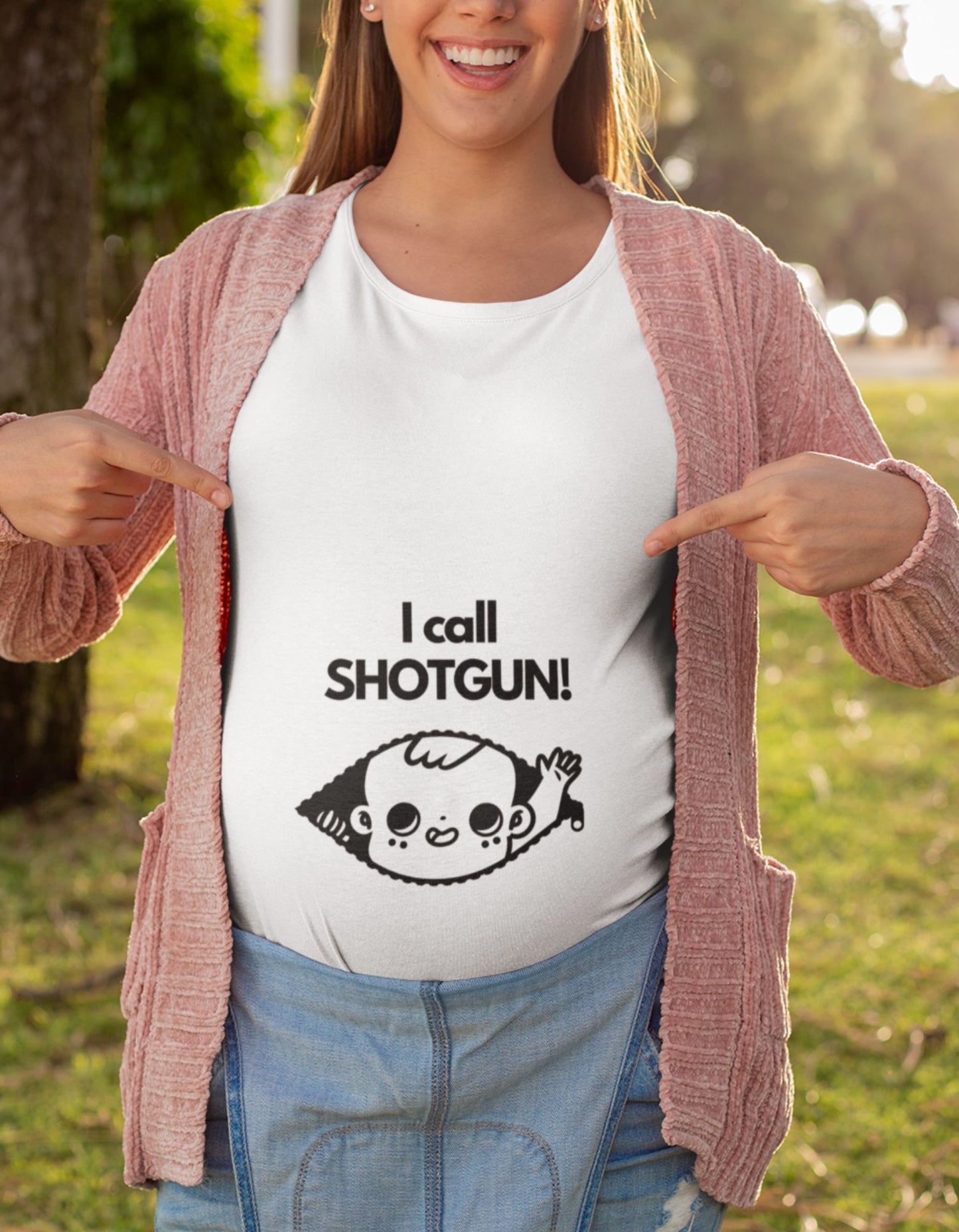 Elevate your maternity wardrobe with our oversized pregnancy t-shirt. Designed with a baby peaking out of a zip and raising a hand, our 'I Call Shotgun' t-shirt adds a playful touch to your style. Embrace comfort and make a statement of motherhood at Womanitee!