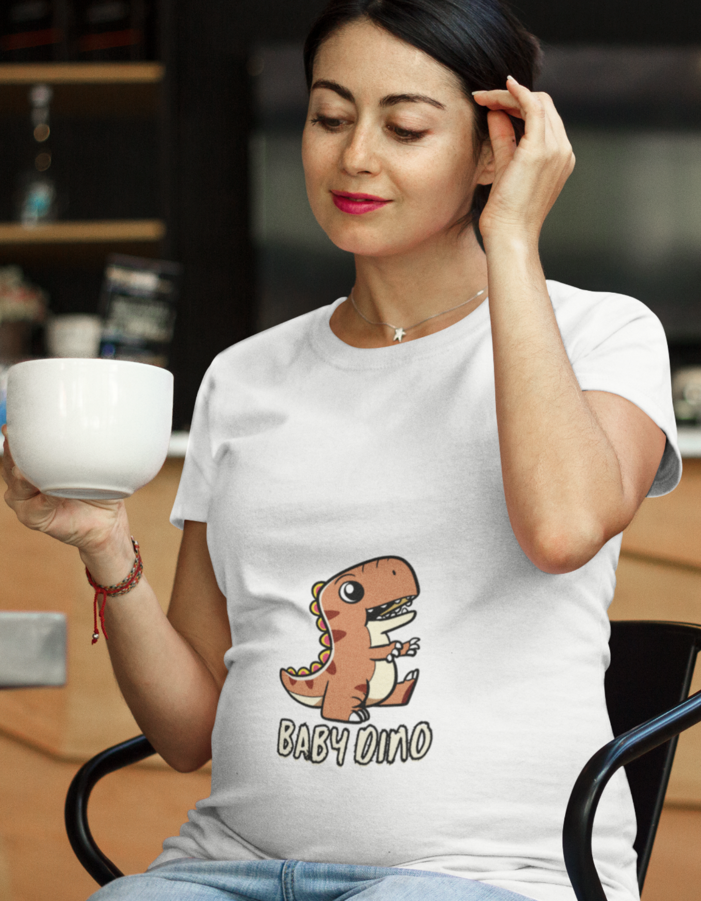 Discover a wide range of women's graphic t-shirts online in India at Womanitee. Express your unique style with our cute and comfortable Baby Dino Pregnancy T-Shirt. Shop now and make a fashion statement!