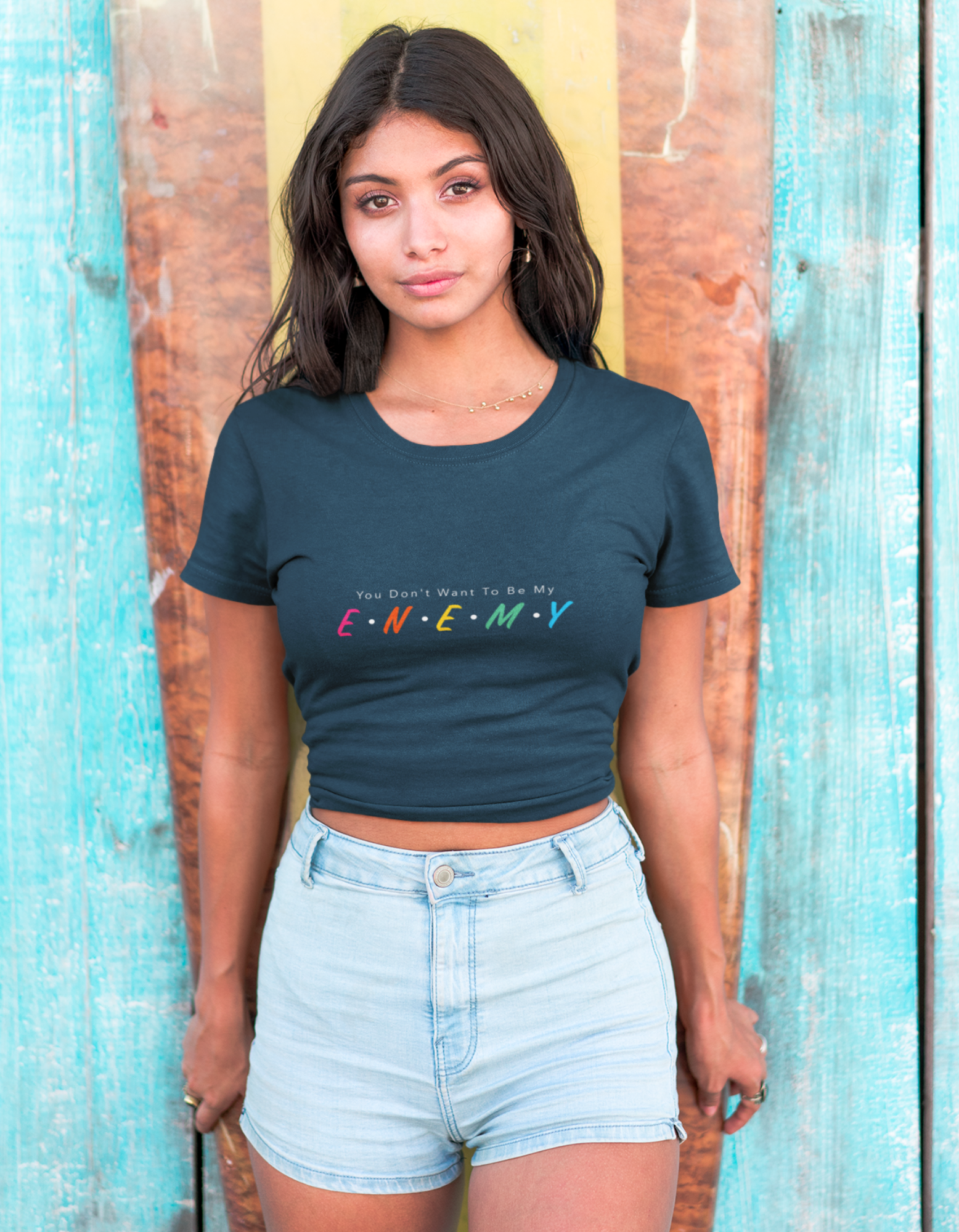 Want to get noticed? Our Womenitee navy blue crop top with the message "you don't want to be my E.N.E.M.Y" is the perfect choice. With its bold and sassy style, this top is sure to turn heads. Shop now and add a touch of attitude to your wardrobe! 