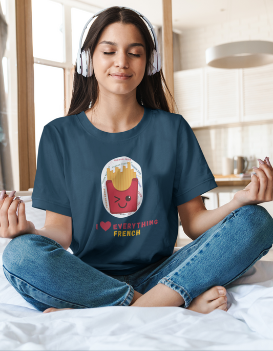 Celebrate your love for French fries and all things French with our playful t-shirt featuring a cute illustration of a winking box of French fries and the mischievous message "I Love Everything French." Shop now at Womanitee, the best place to buy women's graphic tees online in India, and show off your French fries obsession.