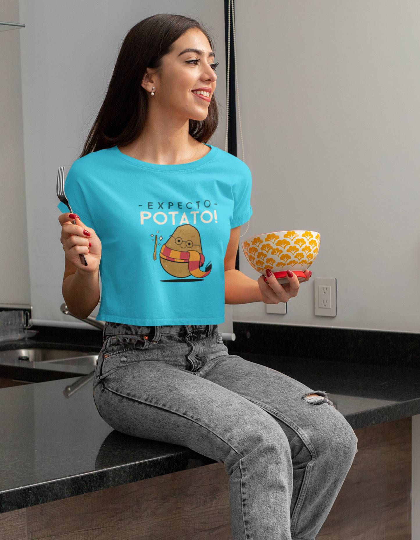 Elevate your fashion game with our Sky Blue Crop Top featuring the 'Expecto Potato' design inspired by Harry Potter. Shop online at Womanitee for women's crop tops and embrace the magic of the iconic series. Buy now and let your style enchant everyone around you!