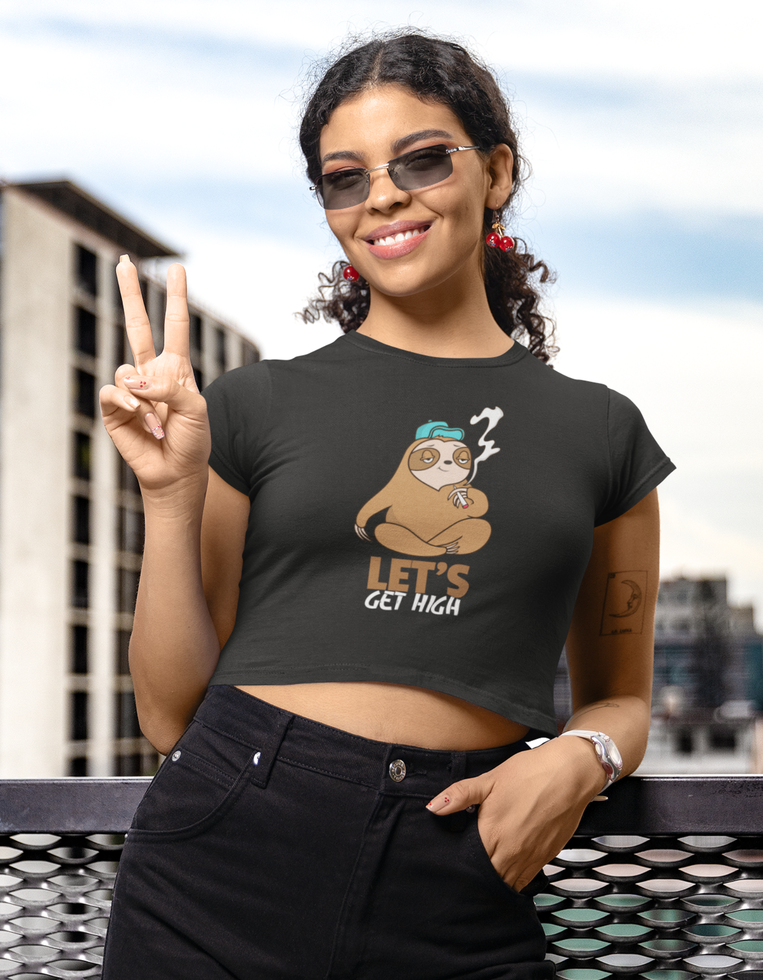 Elevate your fashion game with our Women's Black Sloth Crop Top. This quirky crop top, adorned with a cute sloth illustration and the humorous message 'Let's Get High', adds a playful touch to your wardrobe. Shop online at Womanitee for women's round neck cotton crop tops in India.