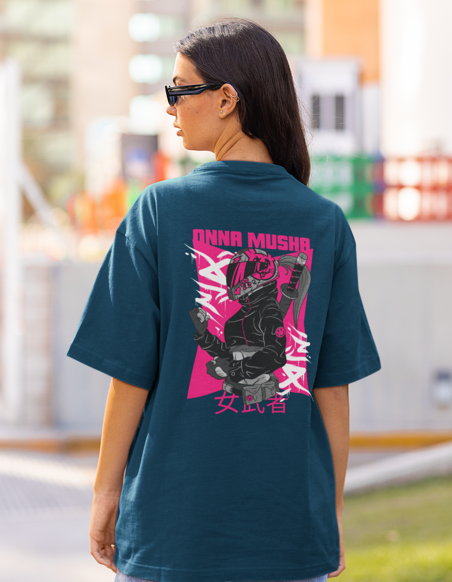  Embrace your inner warrior with our navy blue oversized t-shirt showcasing a striking illustration of a modern-day warrior woman and the powerful words "Onna Musha." Order now from Womanitee and let your strength shine through your fashion!