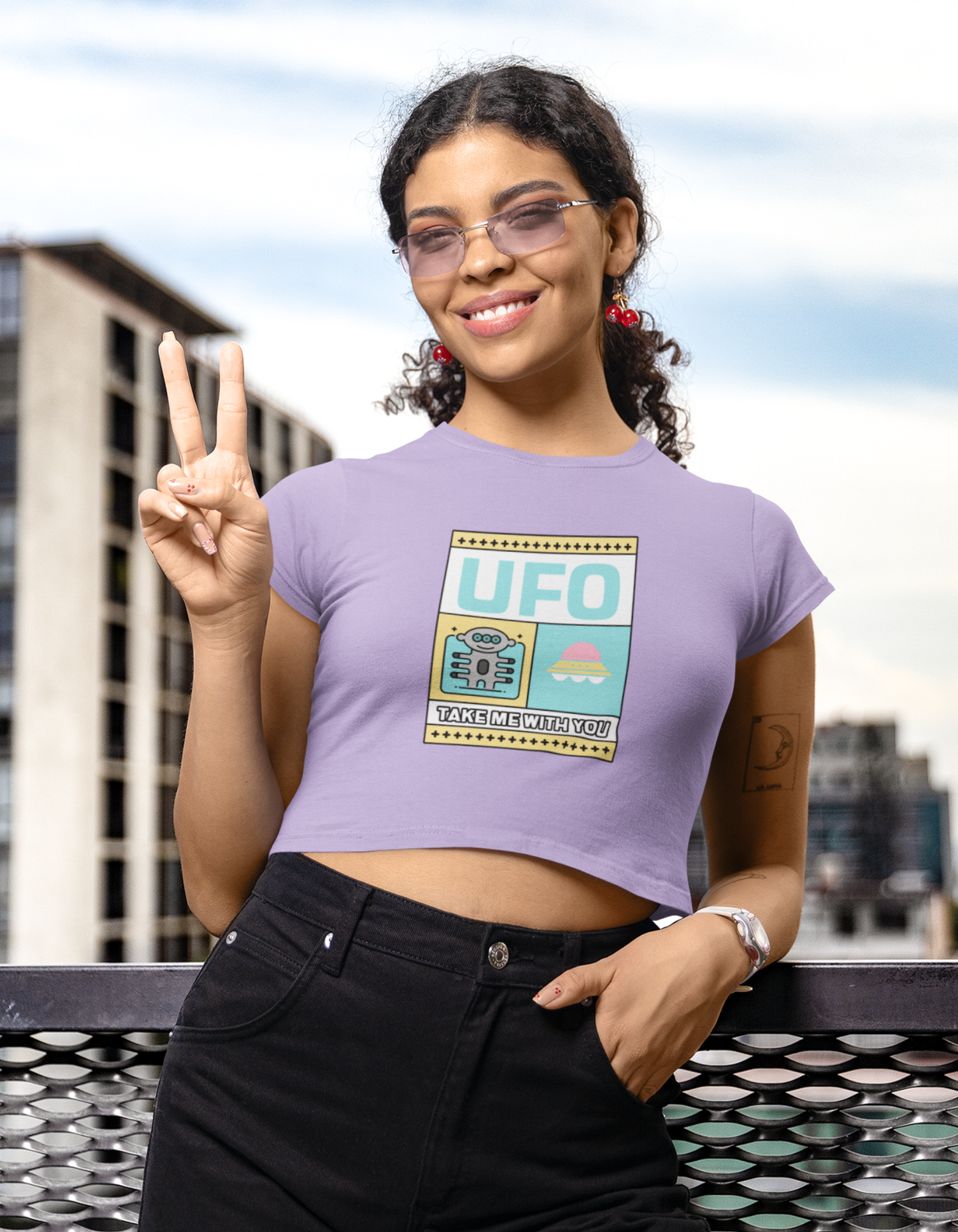 Unleash your unique style with our Iris Lavender Crop Top. Designed with a playful alien and UFO illustration, this crop top is a must-have for fashion-forward women. Discover a wide range of women's t-shirts and crop tops online in India at Womanitee. Shop today