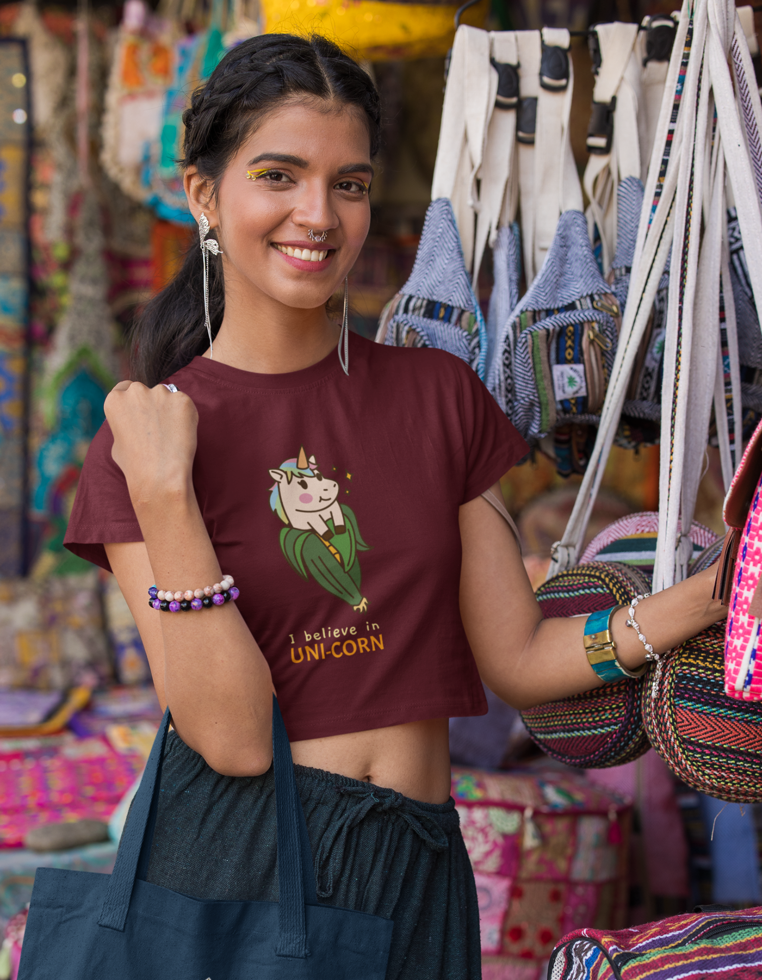 Step into a world of enchantment with our maroon crop top featuring a charming unicorn coming out of a corn cob and the magical phrase "I Believe in Unicorn." Made from comfortable fabric, this crop top is perfect for dreamers.