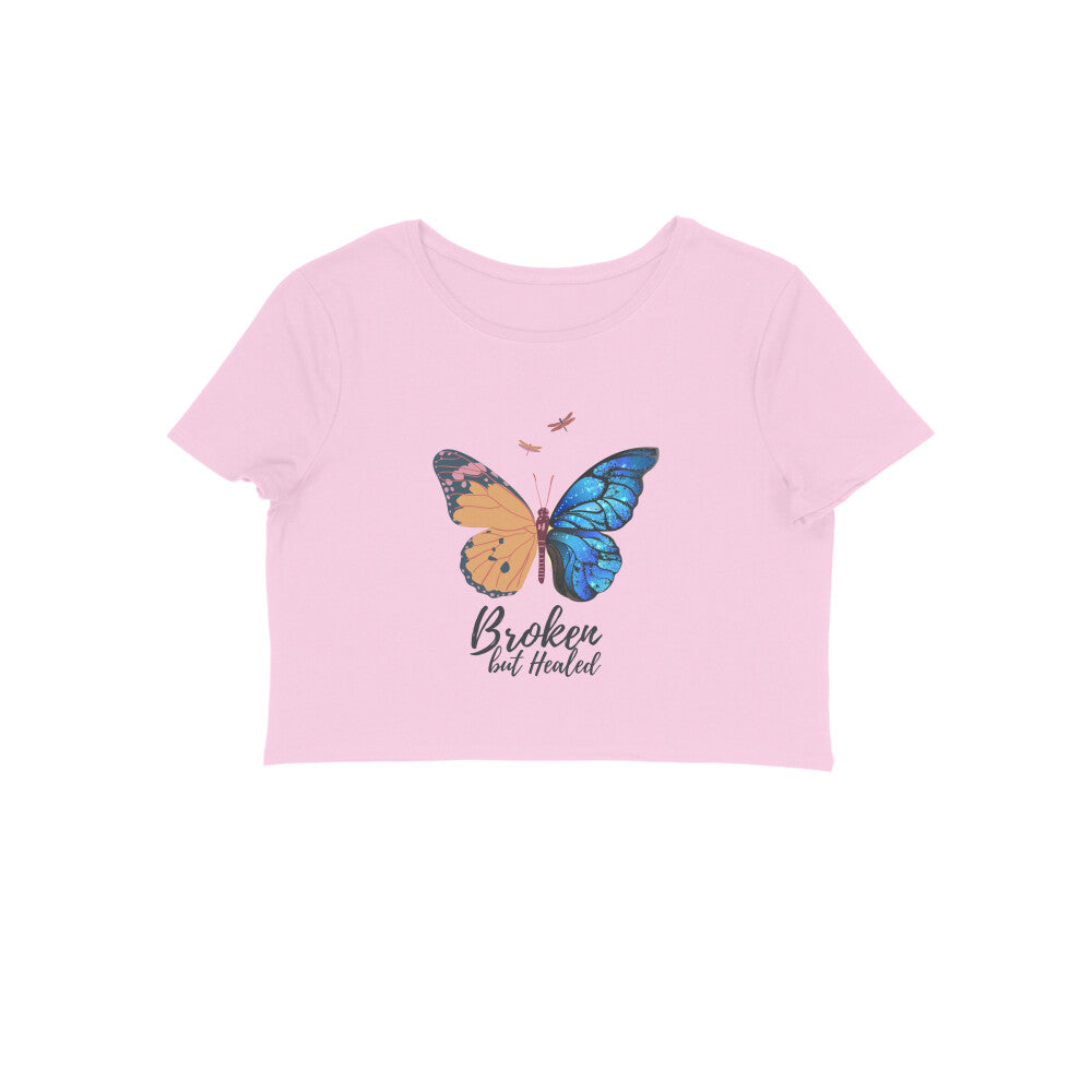 Wear your journey proudly with our Women's Butterfly Crop Top. The stunning butterfly illustration, symbolizing strength and healing, along with the phrase 'Broken but Healed,' makes this shirt a powerful reminder of the beauty that arises from embracing your scars. Shop now at Womanitee!