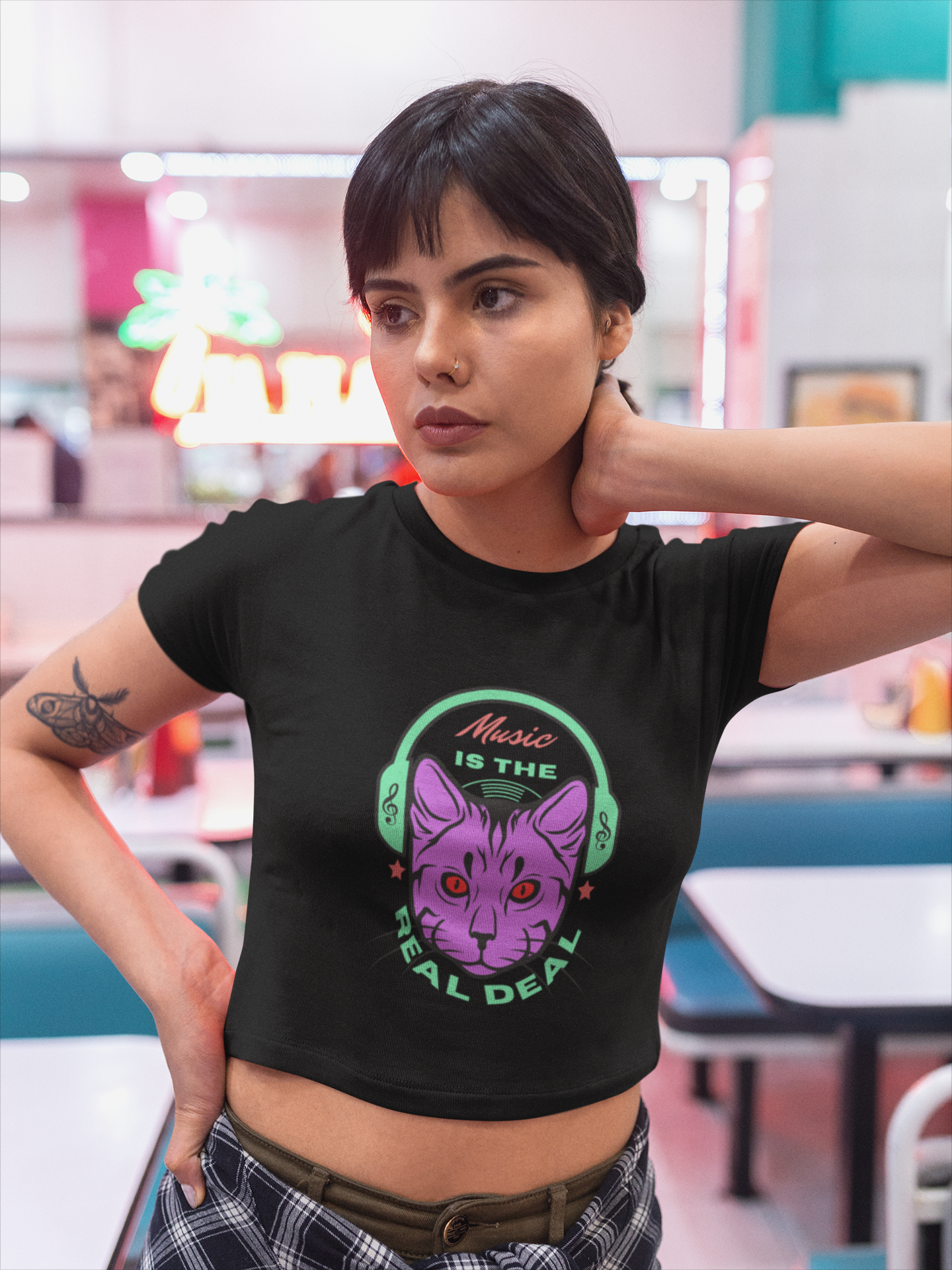 Get in tune with fashion and feline vibes with our Women's Music Meow Crop Top. Featuring an adorable cat illustration and the phrase 'Music Is the Real Deal,' this shirt is a purrfect blend of style and passion. Explore Womanitee's collection of women's t-shirts online in India and express your love for music and cats.