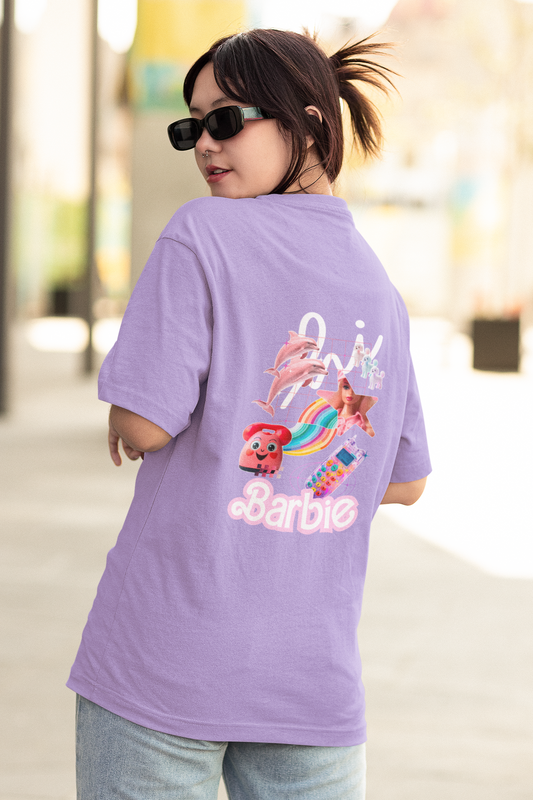 Embrace the magic of Barbie with our Iris Lavender Oversized T-Shirt inspired by the iconic movie Barbie 2023. Shop online at Womanitee for trendy women's graphic t-shirts and relive your favorite childhood moments with Barbie.