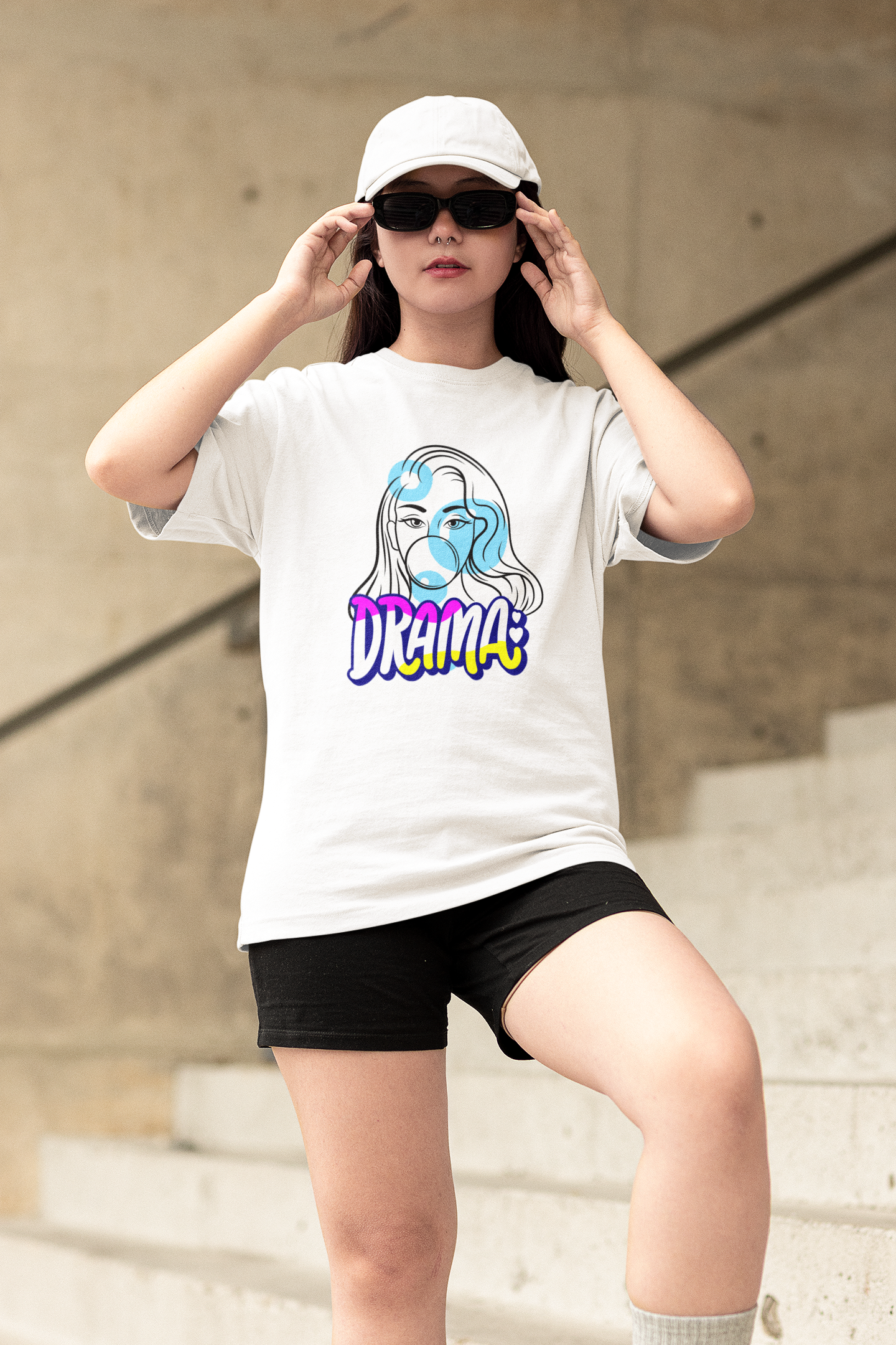 Unleash your inner drama queen with our White Oversized T-Shirt featuring an outline face of a girl and the word "Drama." Shop online at Womanitee for trendy women's graphic t-shirts and embrace your confident and expressive style.