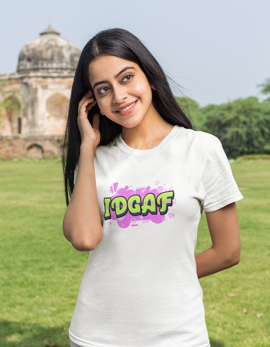 Show off your rebellious spirit with our white t-shirt featuring daring "IDGAF" typography and a playful pink graffiti background. Made from comfortable cotton, this tee is perfect for women who embrace their unique style.