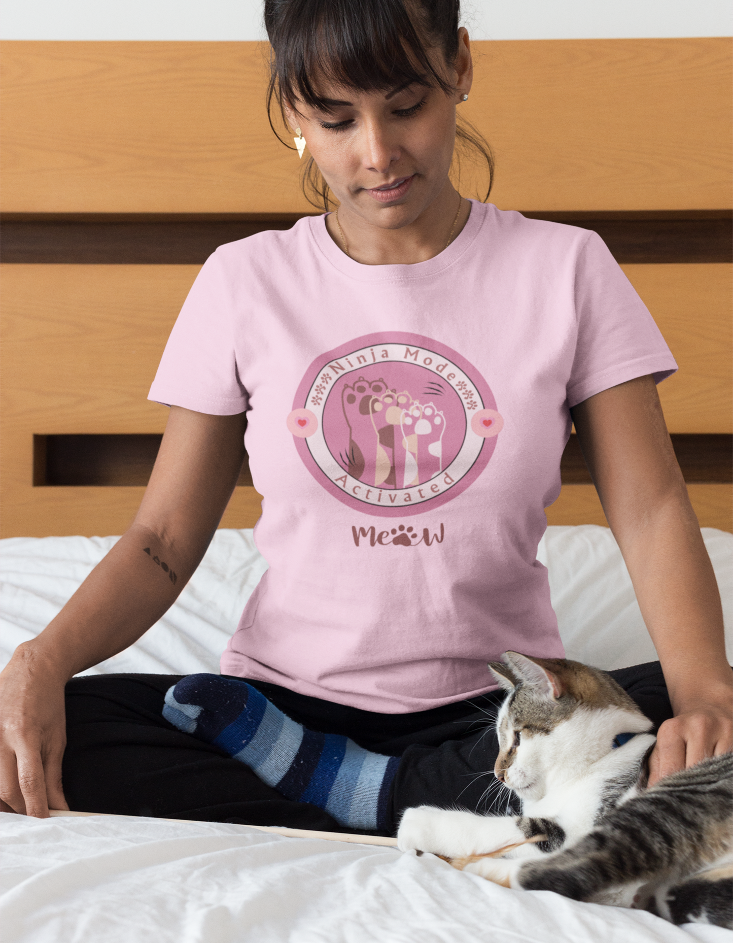 Unleash your inner ninja with our Baby Pink Ninja Cat Paw T-Shirt. Get ready to conquer challenges with style and confidence. Shop now at Womanitee.