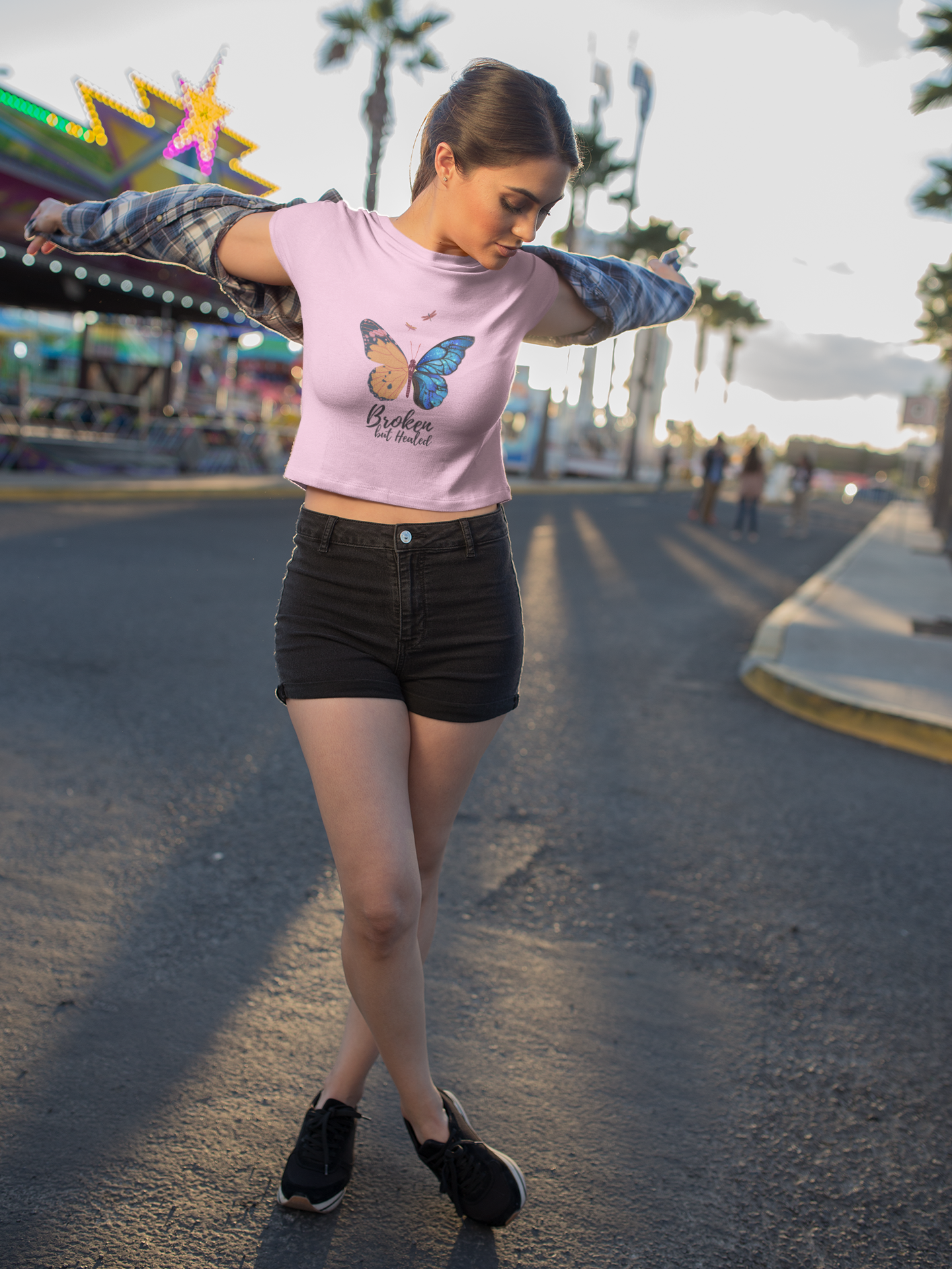 Make a powerful fashion statement with our Women's Butterfly Crop Top. With its eye-catching butterfly illustration and the empowering words 'Broken but Healed,' this shirt blends style and symbolism to celebrate the modern woman's journey of strength and healing. Explore Womanitee today